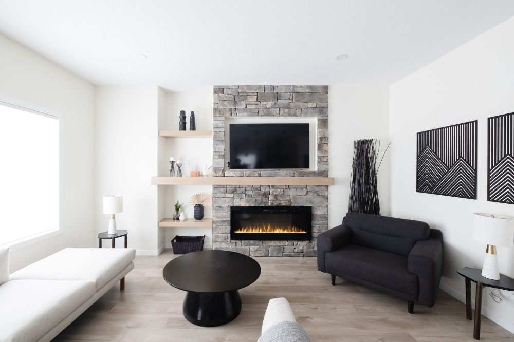 Living room with stone fireplace in a Crawford Homes show home